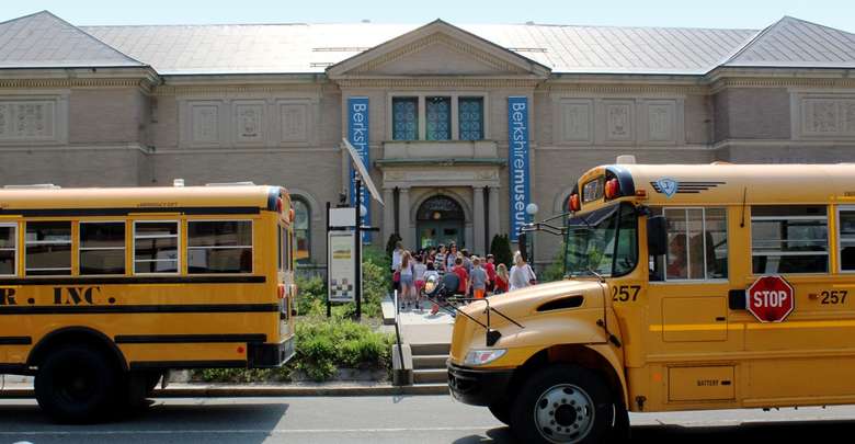 school buses outside a museum