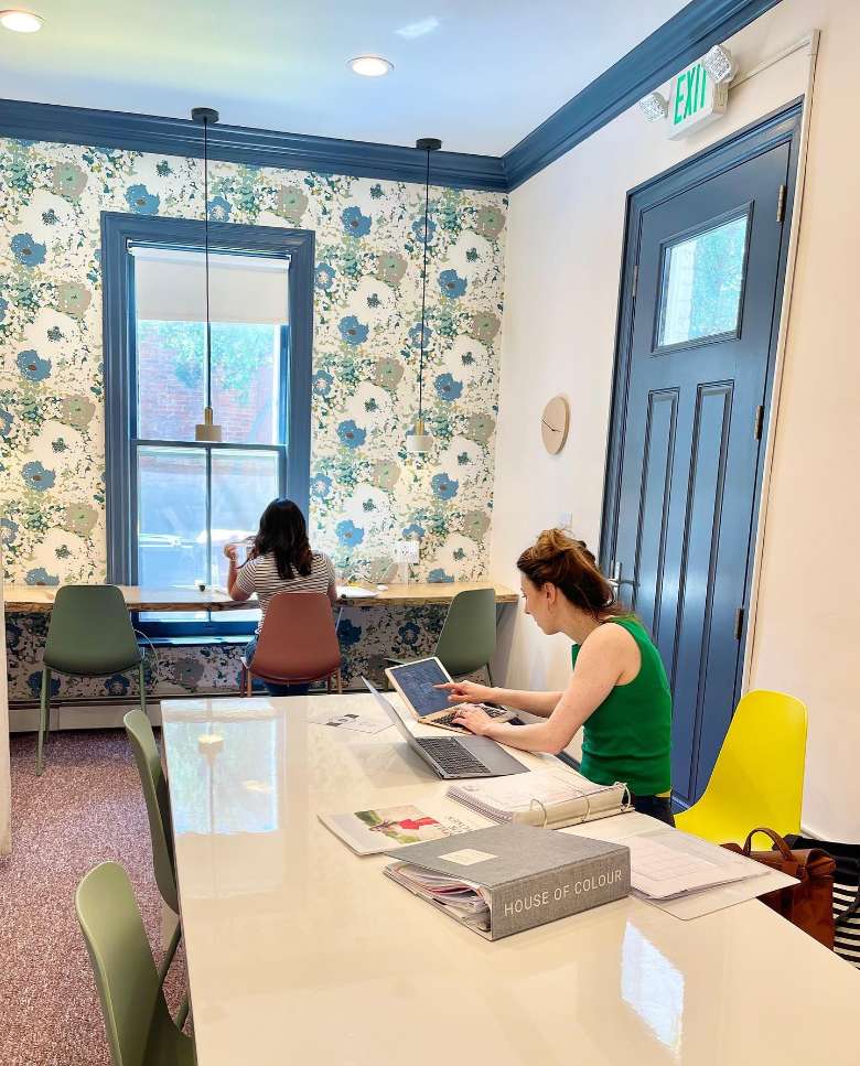 women seated at desks in a coworking room