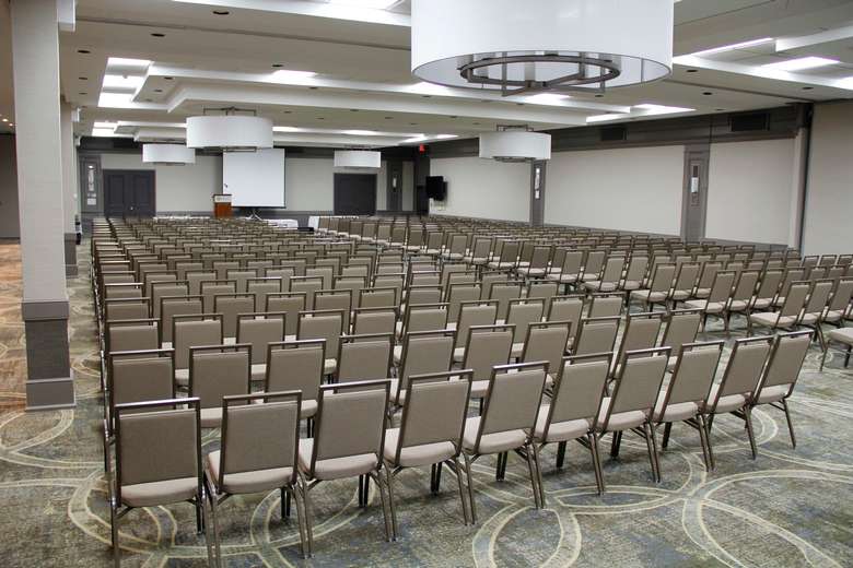 large conference room with rows of chairs for the audience