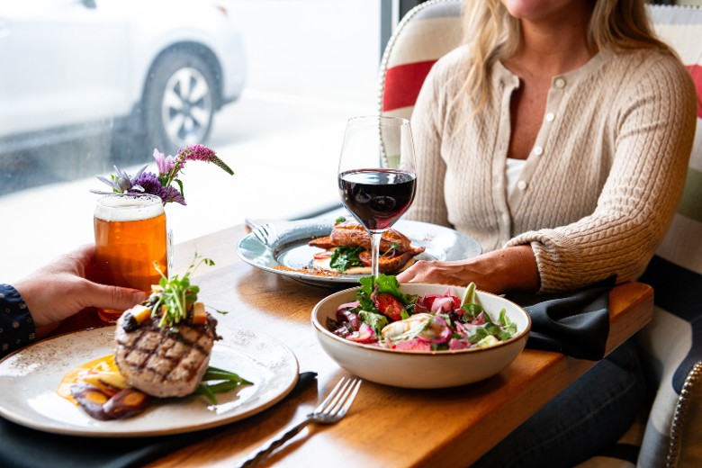 Guests dining at Campfire Adirondack Grill and Bar inside Hotel Saranac