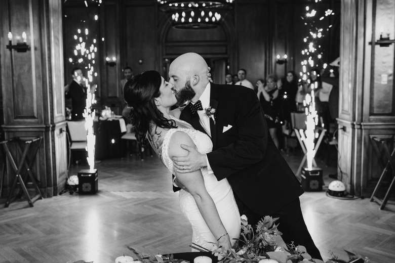 black and white photo of bride and groom kissing