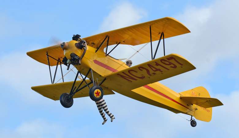 a yellow airplane in flight
