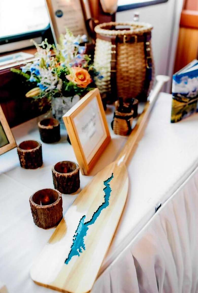 wedding decorations including a paddle with a carving of lake george