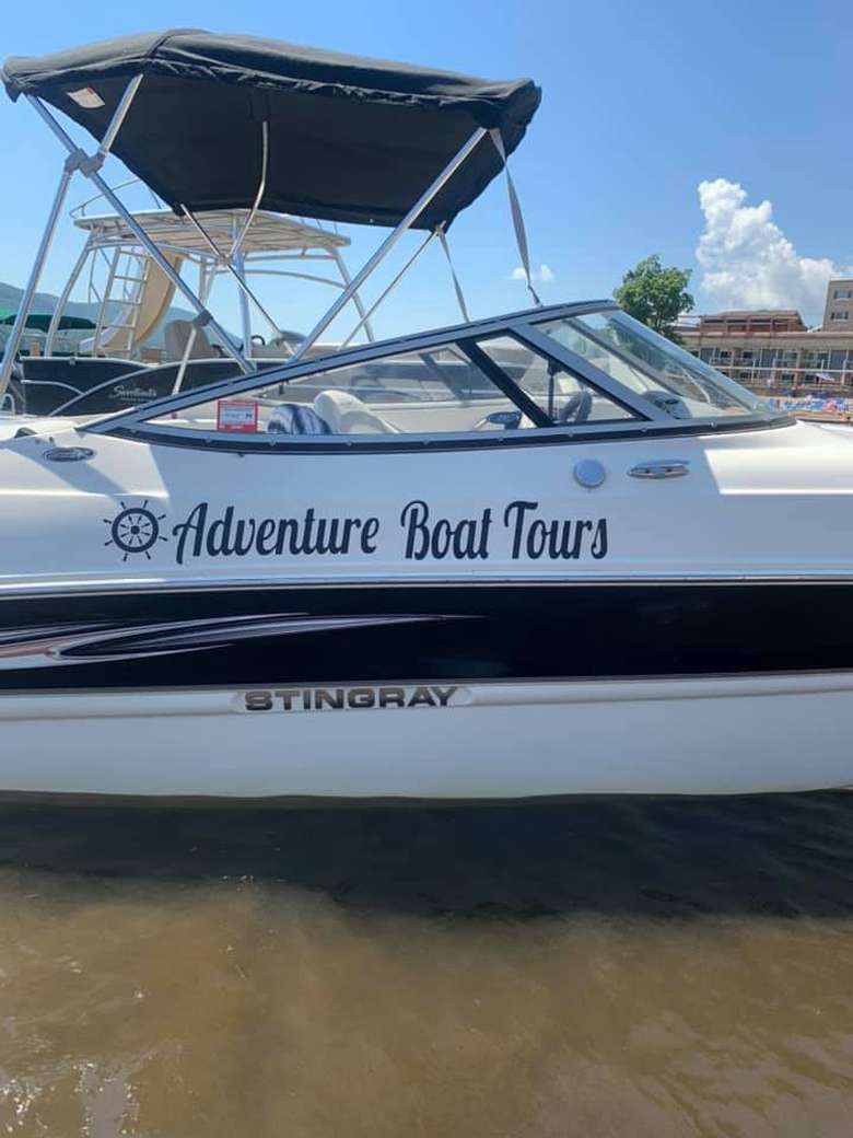 adventure boat tours logo on side of a boat