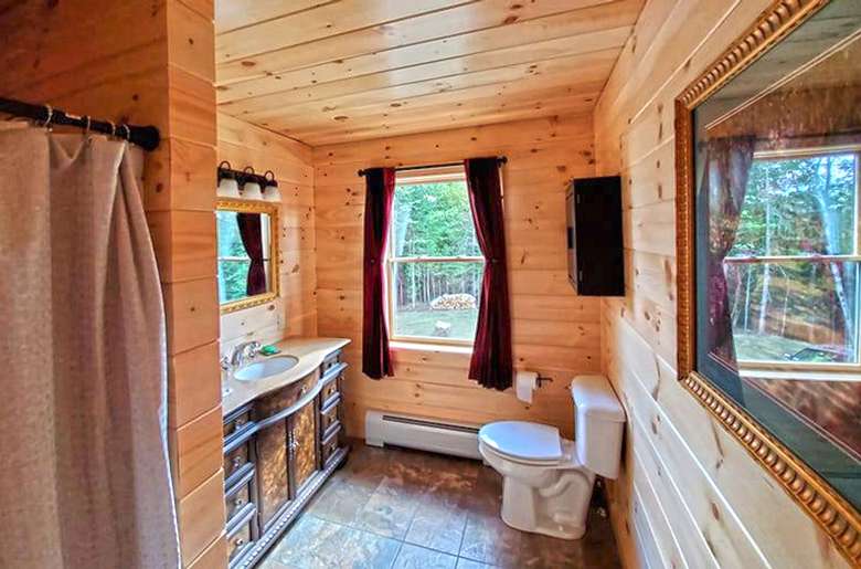 toilet and sink in a rustic bathroom