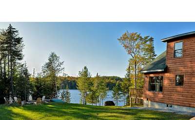 side view of a house, looking at a lake
