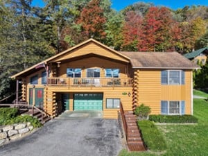 front of the house with trees in the background