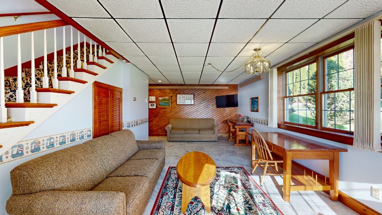 living area with two sofas and a desk