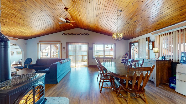 dining room table, gas fireplace and sun streaming in