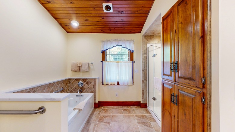 Bathroom with a jet tub visible on the left and a shower on the right.