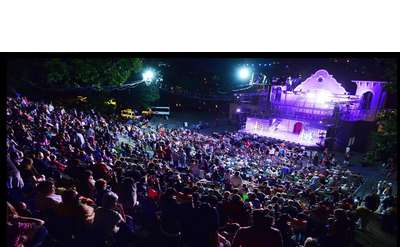 night view of audience watching an outdoor musical