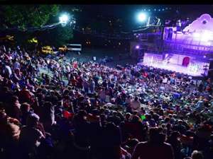 night view of audience watching an outdoor musical