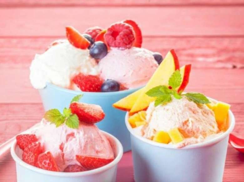 three cups of frozen yogurt with fruit