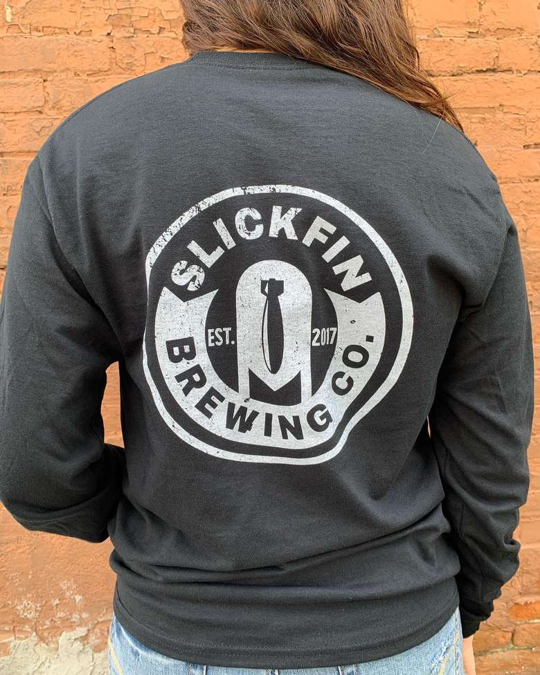 back of a person's shirt with a slickfin brewing logo