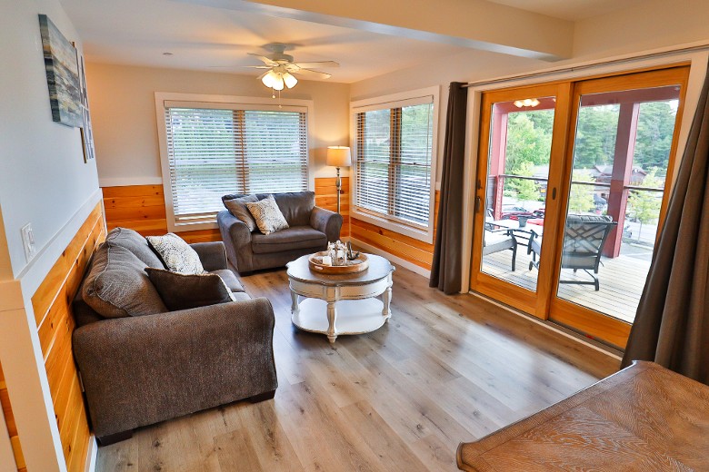 On the main floor is a spacious living room with a pull-out sofa bed and a sliding glass door, giving you access to the lake&rsquo;s balcony