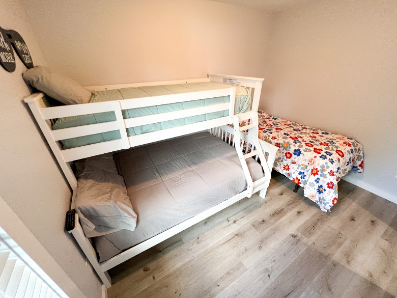 Third floor bedroom with a twin over full bunkbed and a twin bed