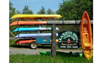 canoes and a sign that says raquette river outfitters