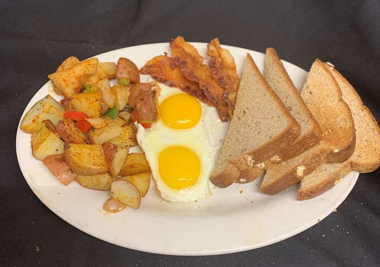 eggs, toast, bacon, and potatoes