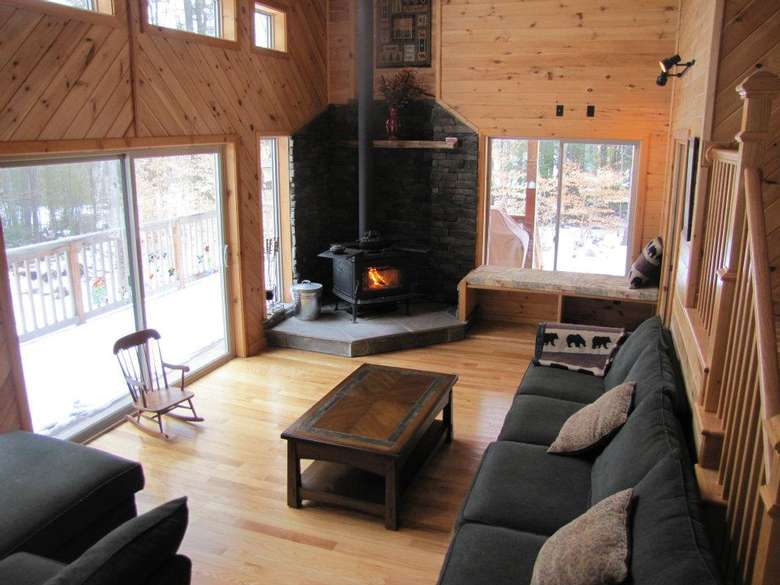 living room with couches and a woodstove