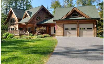 the front of a large house with a garage