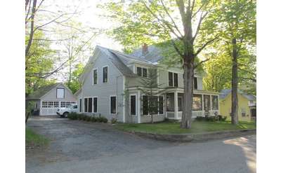 a large white house and driveway