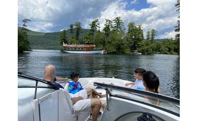 people on a boat looking at another boat