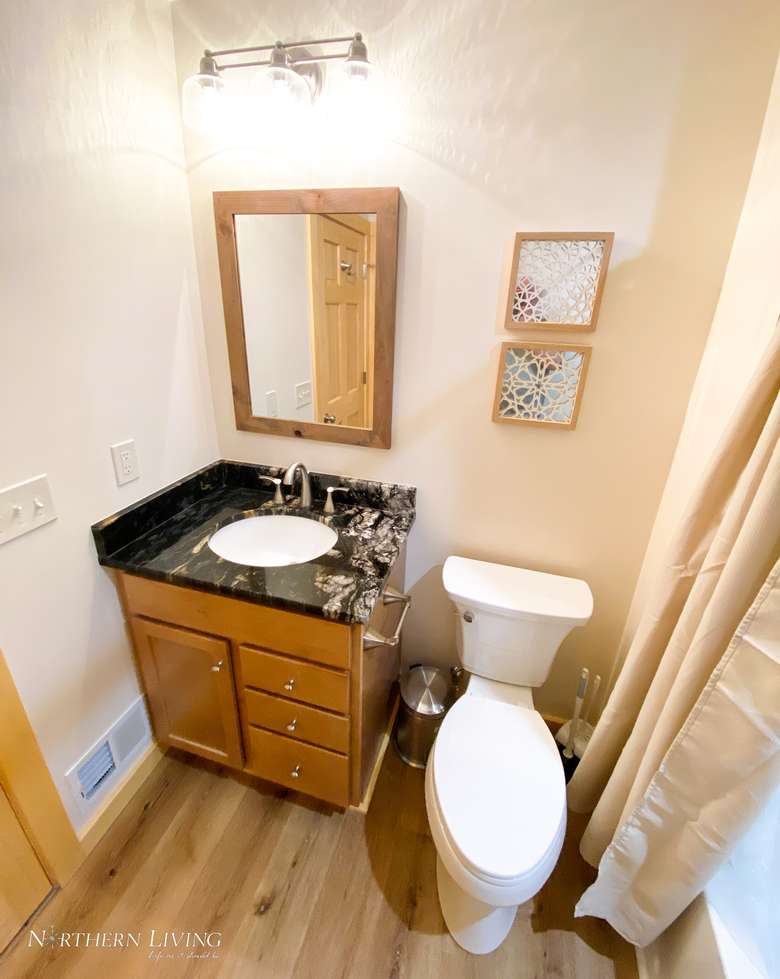bathroom with a sink, a toilet, and a mirror