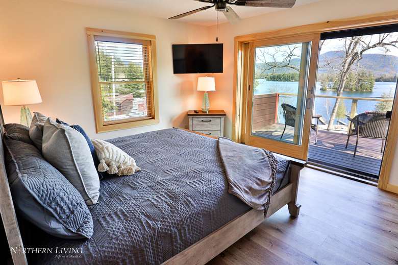 large bedroom with sliding glass doors to a deck