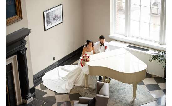 bride and groom at a piano