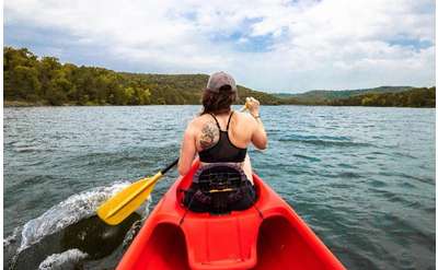 woman in a red kayak on a lake