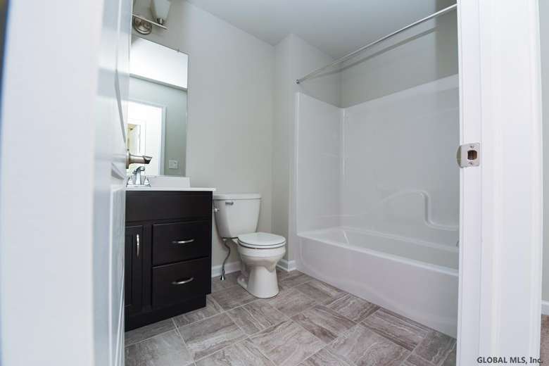 bathroom with tub and toilet