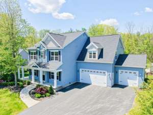 a blue house with two garages