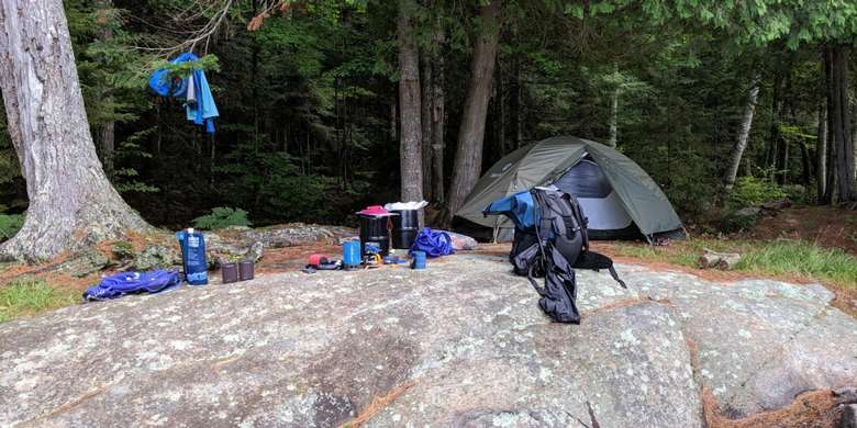 camping gear near a rock