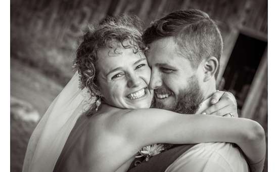 bride and groom embracing and smiling