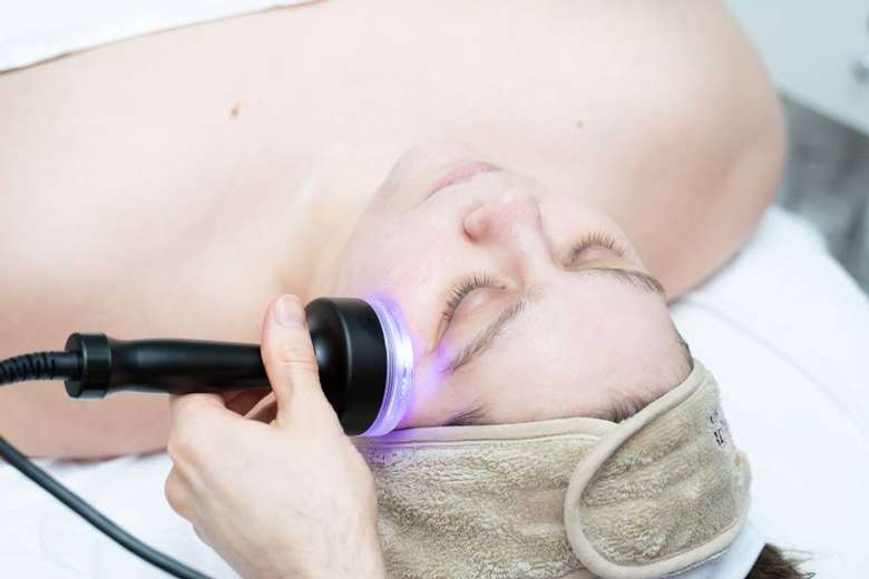 facial equipment being used on woman