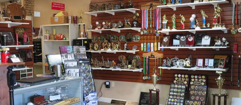 trophies and awards on a wall in a store