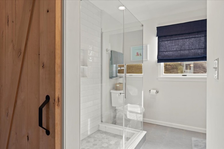 Main level bathroom with shower and double sinks