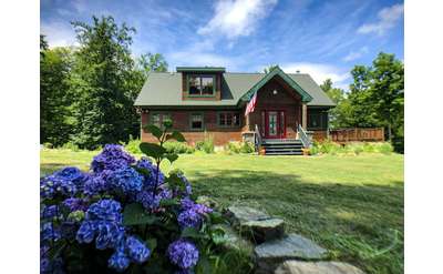 rustic cabin and green lawn