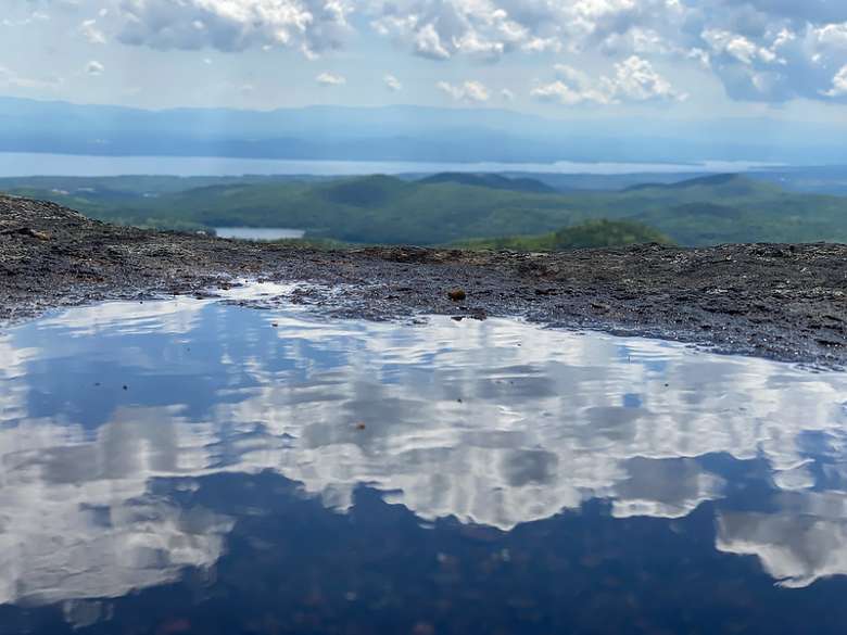 reflection of clouds in a puddle