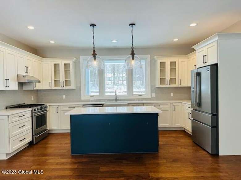 island space in a spacious kitchen with hanging ceiling lights