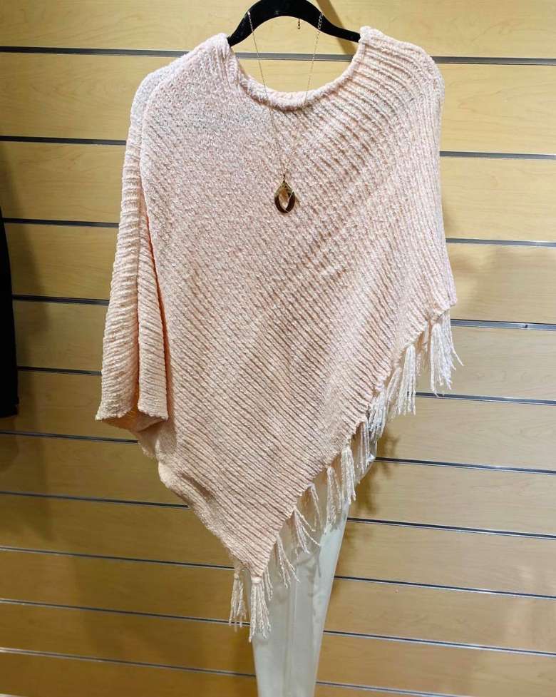 sweater with necklace on hanger