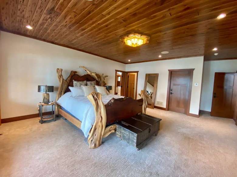 large bedroom with a rustic bed frame