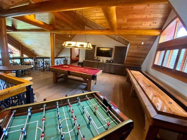 game room in a house with pool and foosball