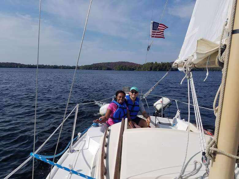 man and woman at the back of a sailboat