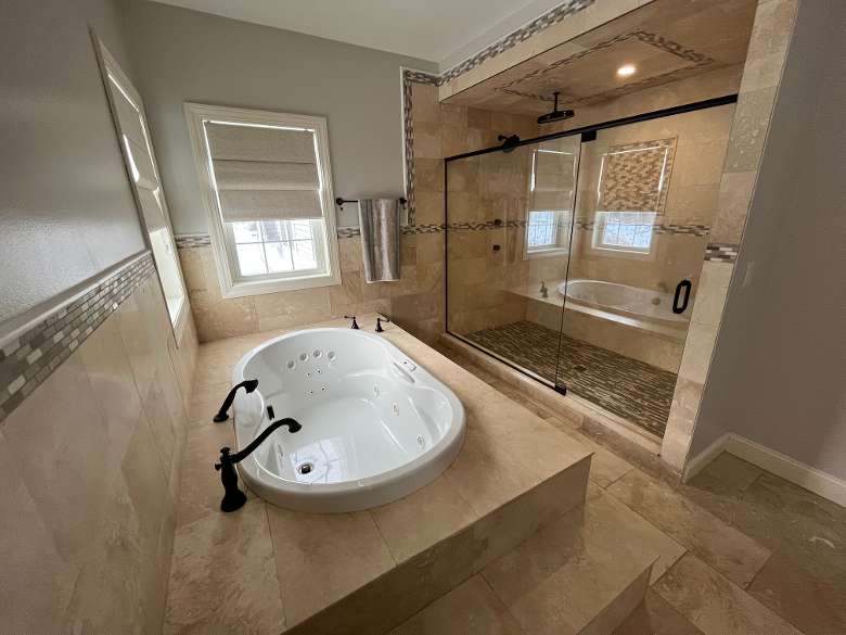 Master bathroom jacuzzi and rain head shower system with enclosure