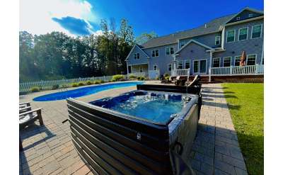 a house backyard with a pool and tub