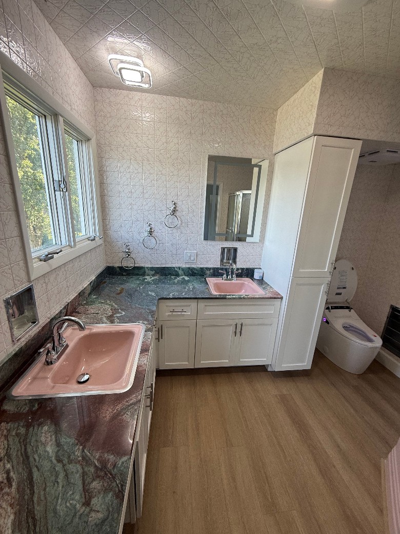 Remodeled master bathroom with new bidet, double vanities with countertops, vent with Bluetooth,