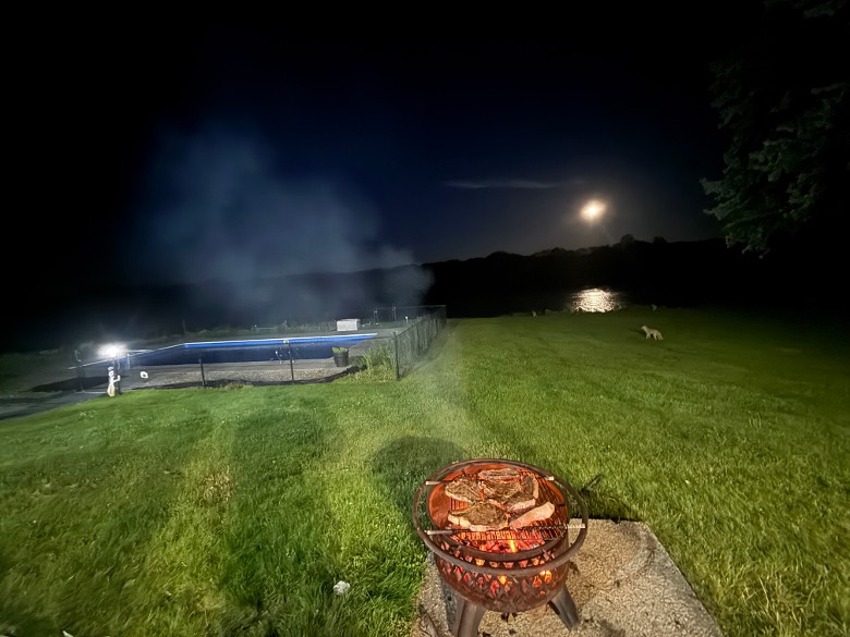 Old fashion charcoal grilling at night - onsite is also a combo propane and charcoal grill for outside cooking