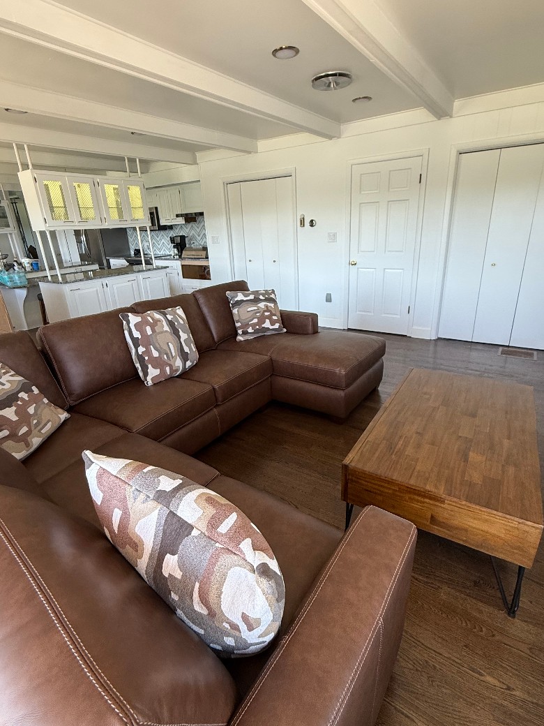Family room with waterfront views out of all windows and screen door out to new patio