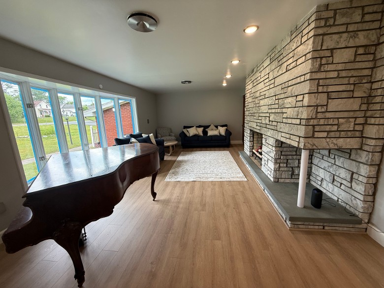 Formal living room with queen sofa pullout bed, love seat, and table